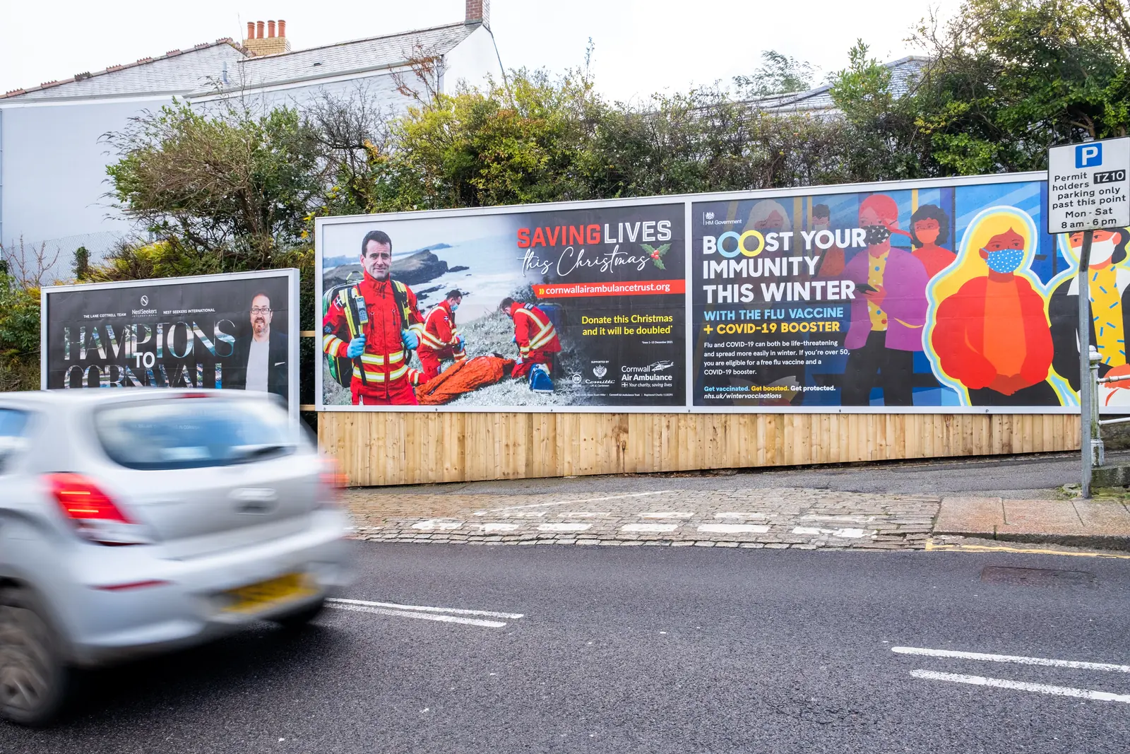 Billboards on Richmond Hill, Truro, with a car going by