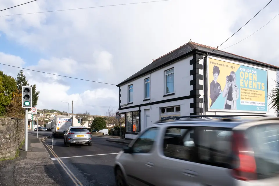 The Tregonissey Road billboard in St Austell with traffic at the green light